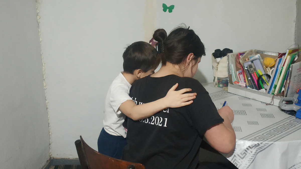 Young boy hugging his older sister 