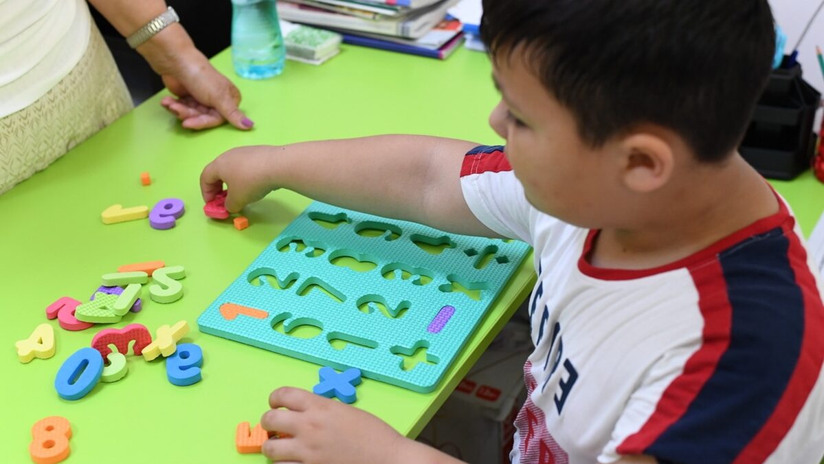 A young boy playing a developmental learning game