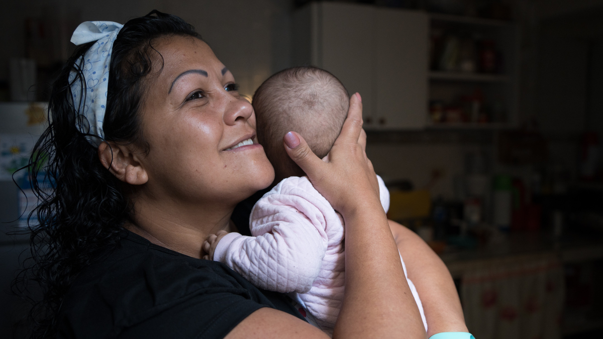 Foster mother from Colombia hugging a baby 