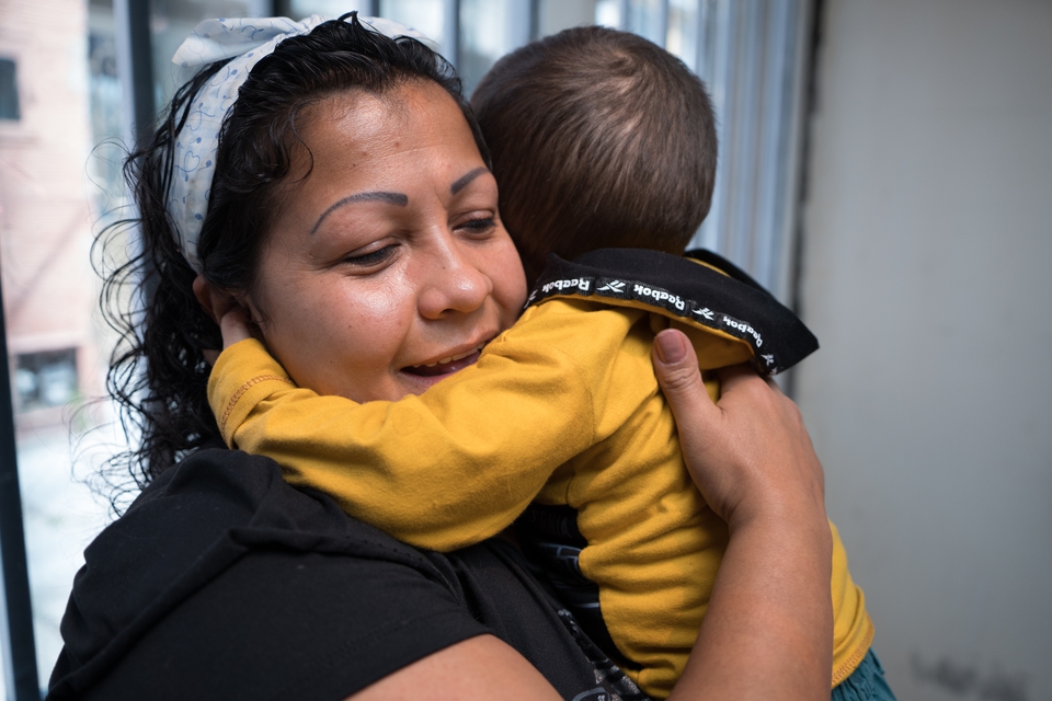 Viviana, a Colombian foster mother is hugging her foster son.